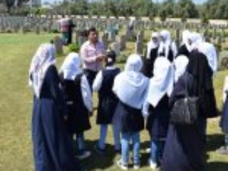 15. A group of students with their teacher enjoying an outdoor lesson at Gaza War Cemetery (Photo courtesy of CWGC)