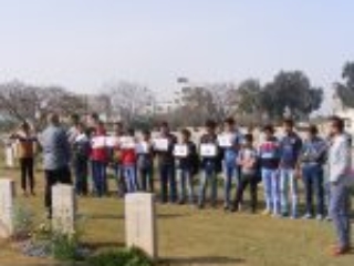 16. A group of students with their teacher enjoying an outdoor lesson at Gaza War Cemetery (Photo courtesy of CWGC)