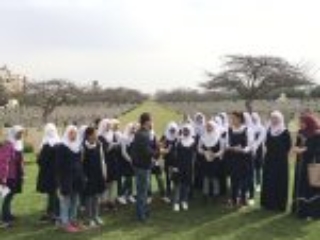 7. A group of students with their teacher enjoying an outdoor lesson at Gaza War Cemetery (Photo courtesy of CWGC)
